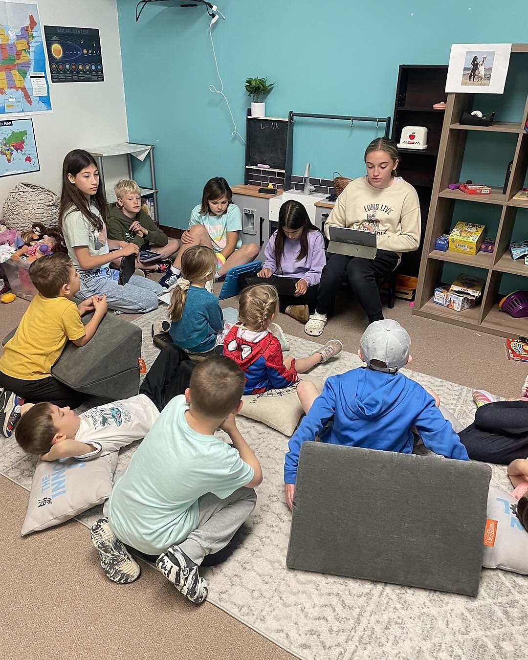 Older students helping younger at the Innovation School.