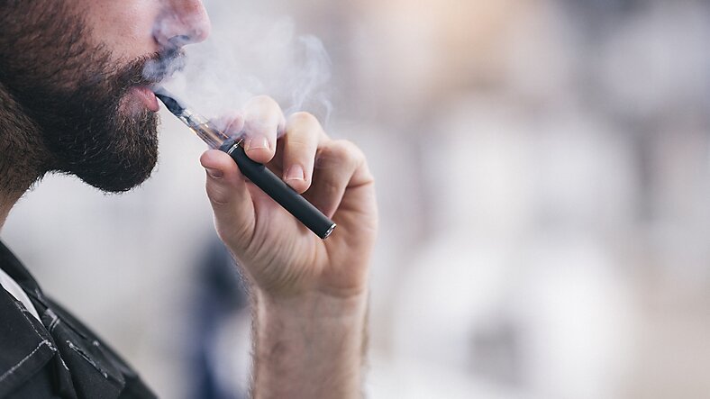 Bearded man vaping